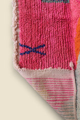Close-up of Zafira rug showing texture and Berber blue cross symbol on pink