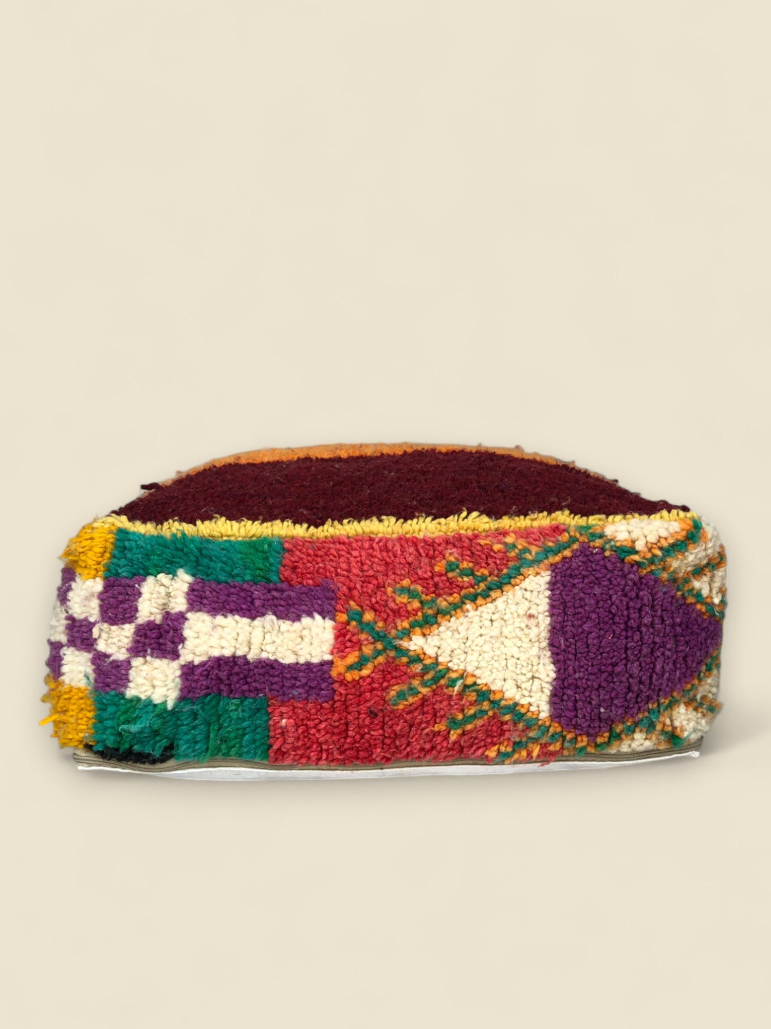 Colorful Moroccan pouffe side view with diamond and stripe motifs