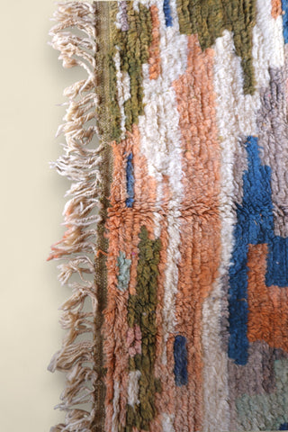 Fringed edge of the Temzine rug with visible wool knots and weft