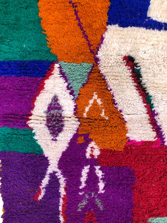 Detailed pattern in orange, green, and diamond motifs on Asalas Berber rug