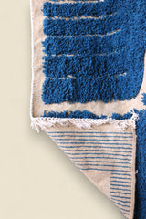 Lower section of rug with horizontal blue stripes and bold contrast

