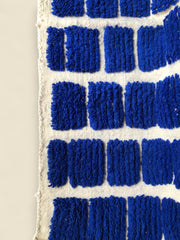 Close-up of blue textured blocks on the Tanit wool rug