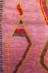  Red and yellow motifs on pink wool background of the Limra Berber rug

