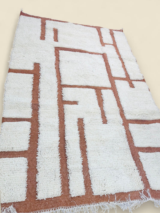 Handwoven Tafenzut Berber Rug with terracotta geometric lines on cream wool background
