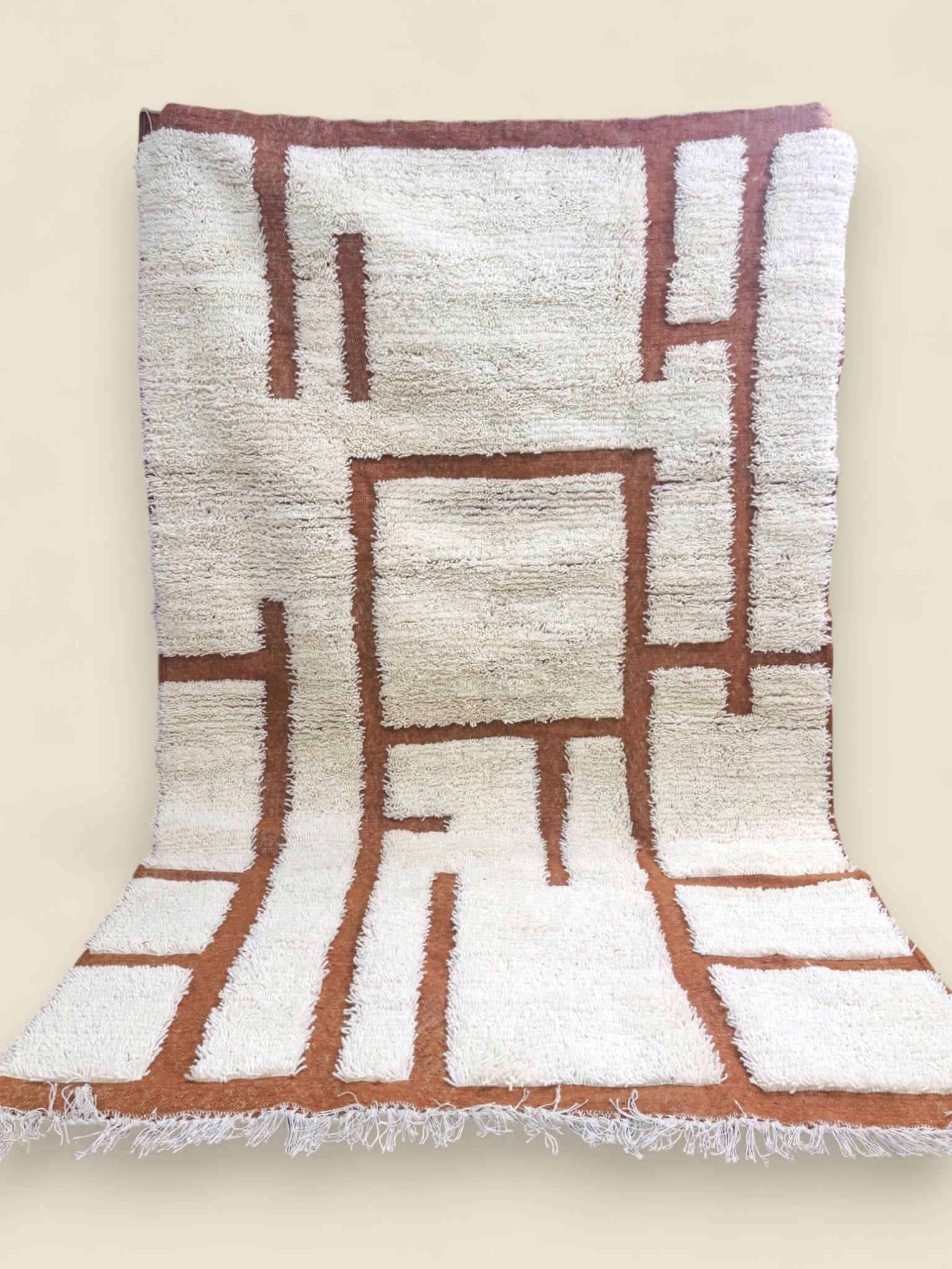Tafenzut handmade Berber rug showing geometric terracotta pattern and fringes