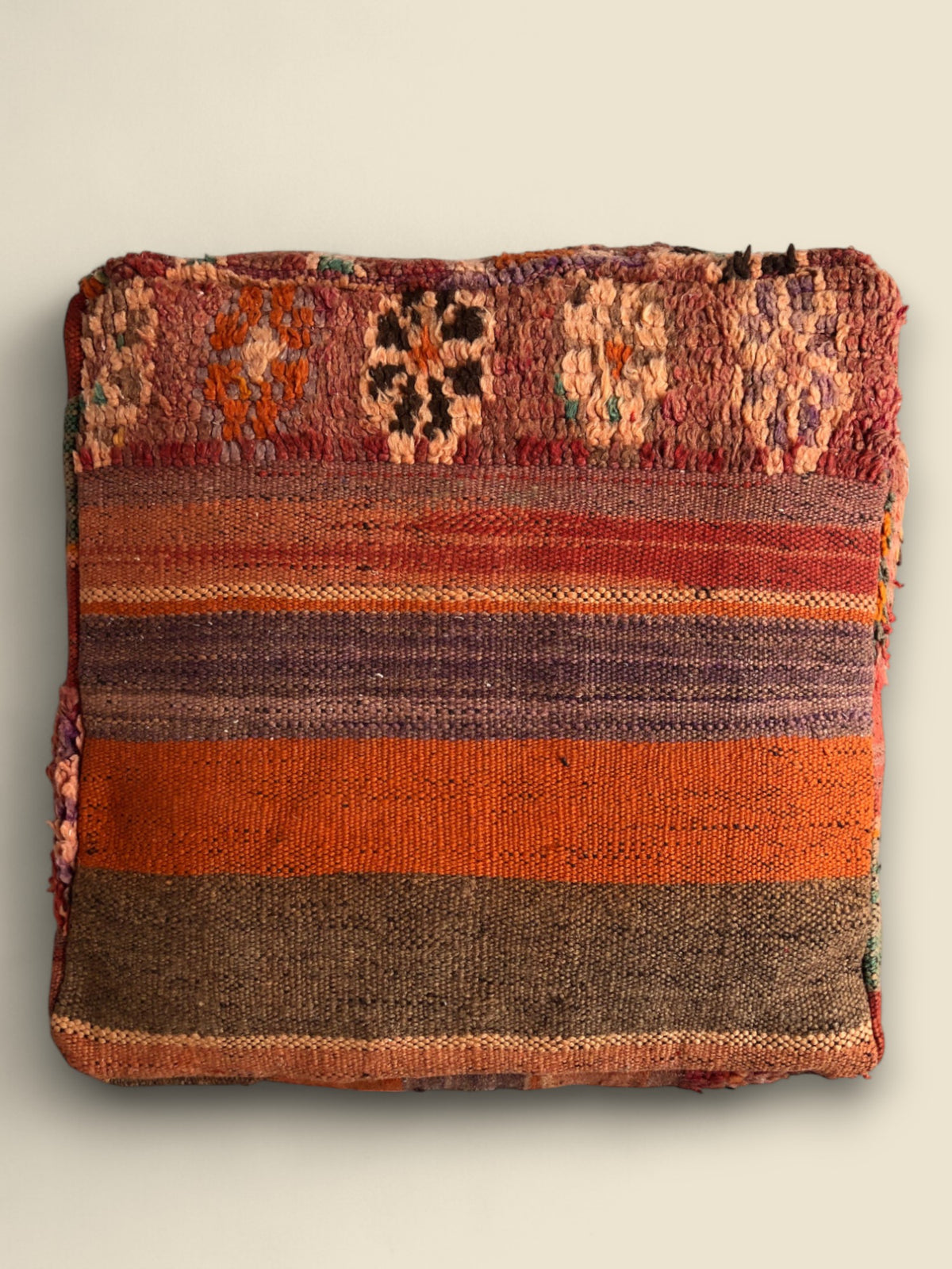 Top view of Tafraout pouffe showing Berber rug patterns and bold stripes