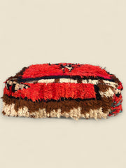  Side of Handwoven Moroccan pouffe with vibrant red and tribal Berber motifs