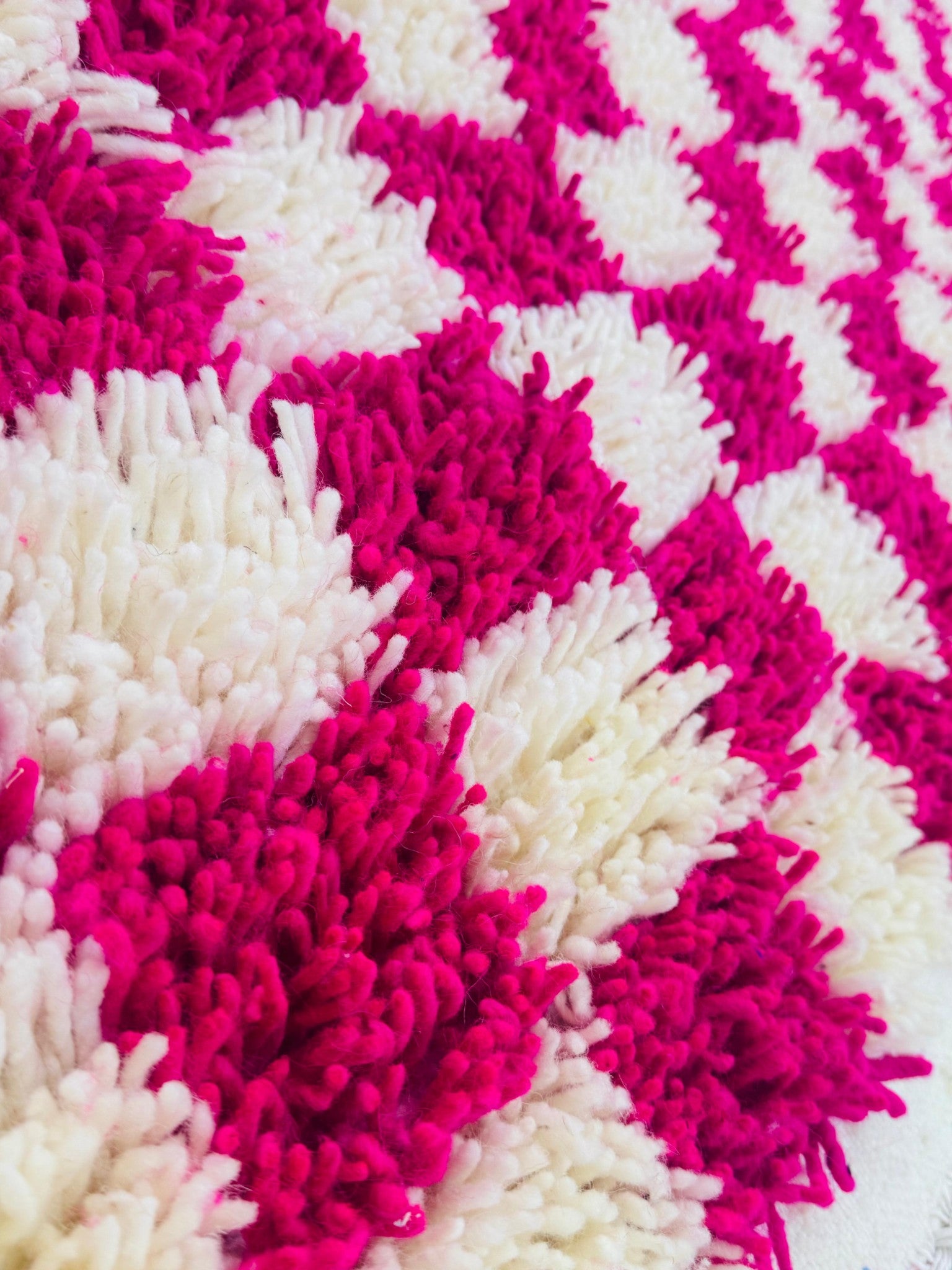 Close-up photo shows the details of the cream and pink wool 