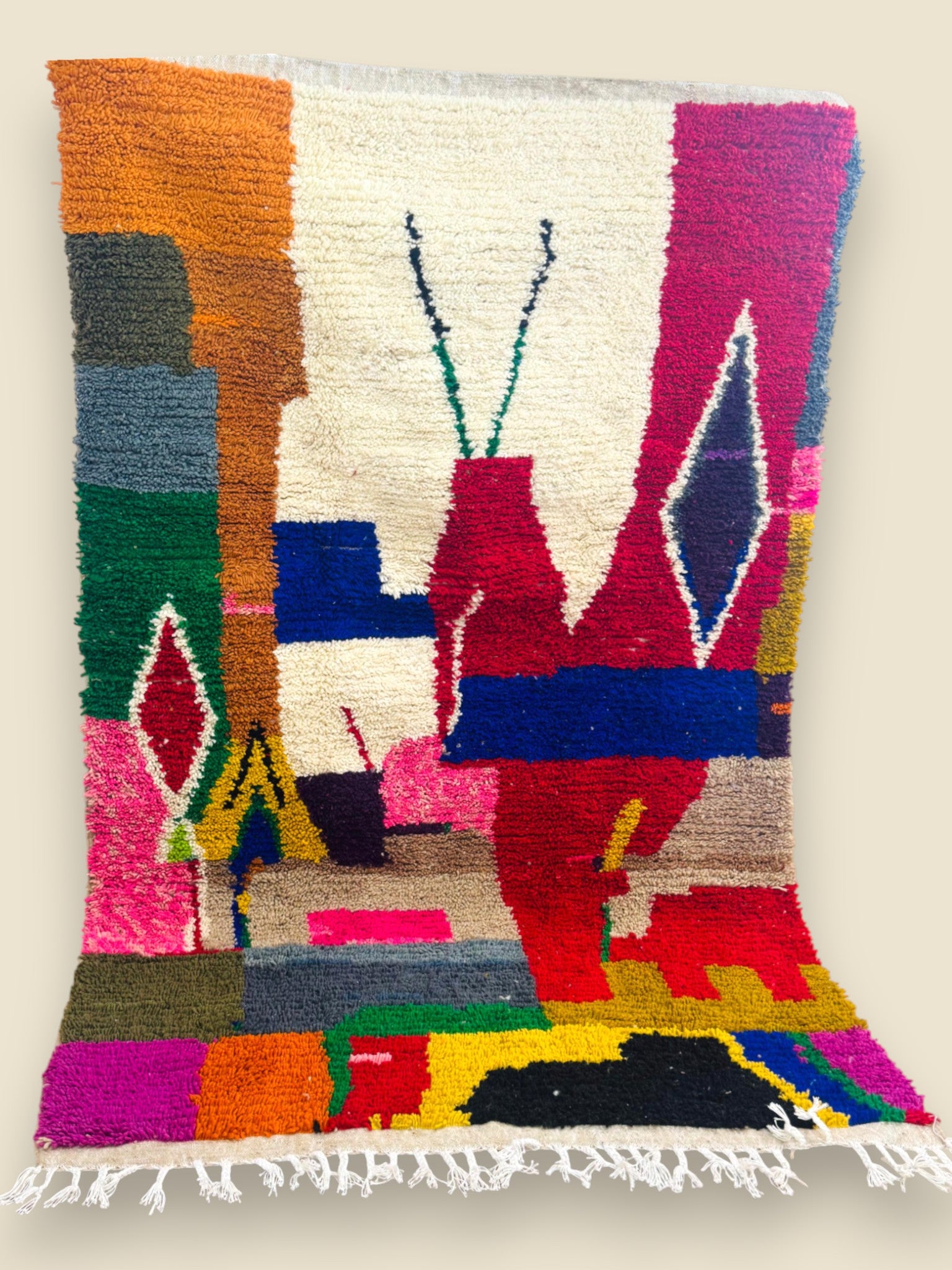 Bright geometric Tawenza Berber rug with red, blue, and cream patterns.