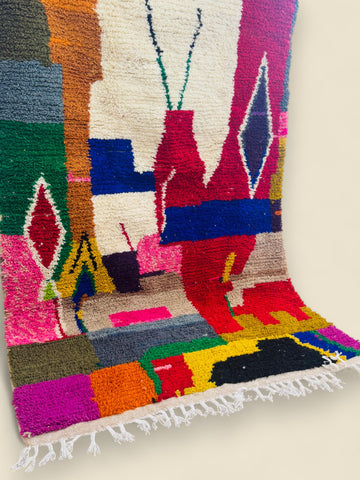 Handmade Moroccan Tawenza rug displayed upright against wall.