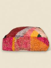 Tawenza Moroccan floor cushion showing pink, orange, and mustard details