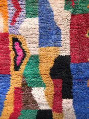 Color block detail of Tazdayt rug in blue, red, green, and yellow.