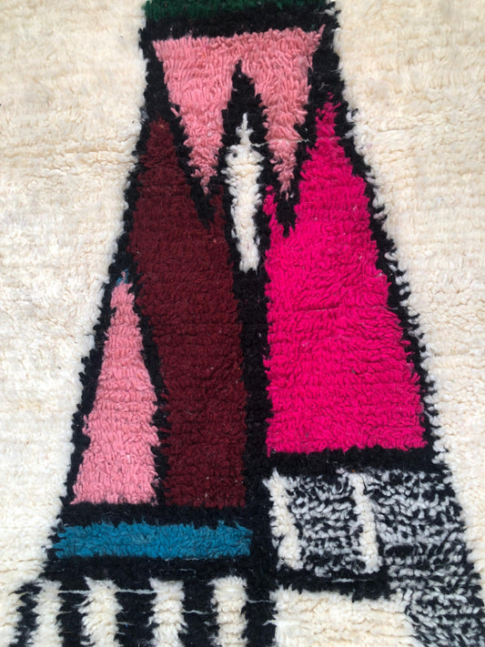 Close-up of the colorful hand-knotted wool sections on a Moroccan Tazghart rug