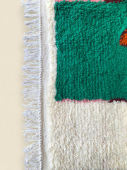 Close-up of the colorful hand-knotted wool sections on a Moroccan Tazghart rug