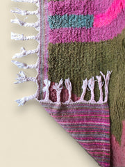 Corner fold of the Tazult Moroccan Rug revealing woven underside and fringe