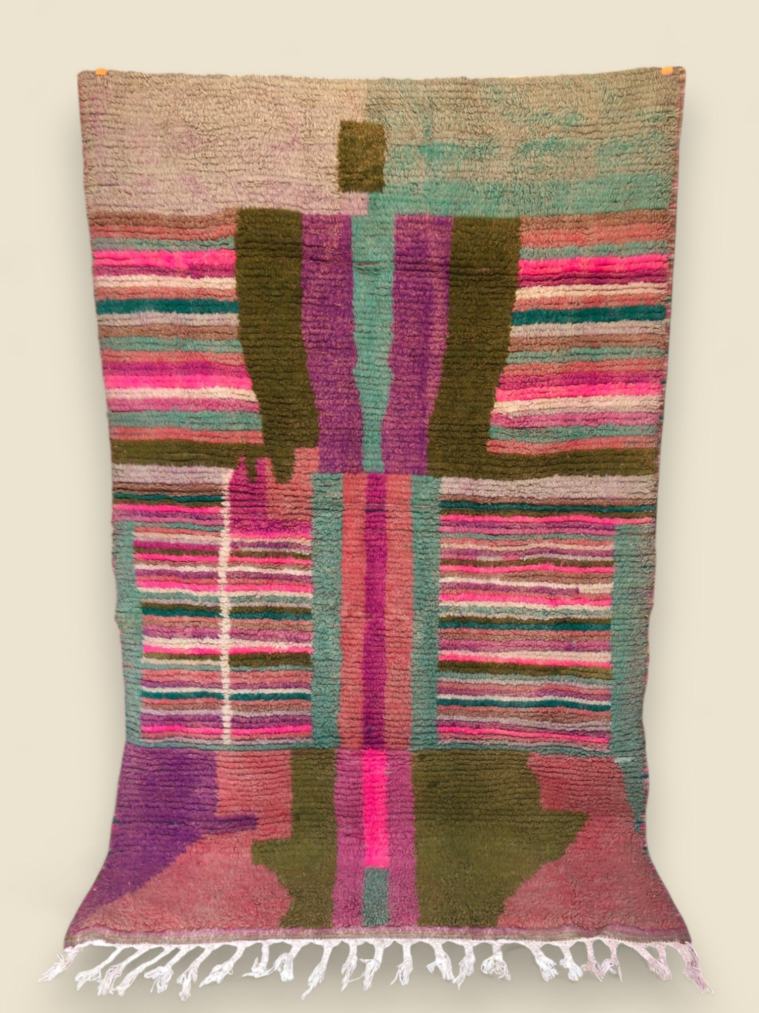  Full view of Tazult Rug hanging, displaying bold central figure and colorful tribal patterns