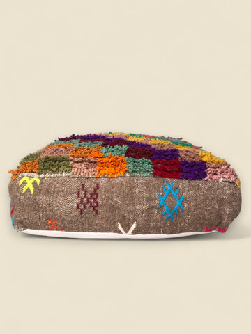 Moroccan pouffe with checkered wool top and Berber symbols on the side