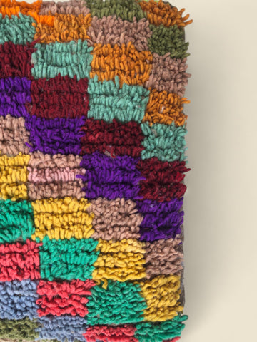 Colorful patchwork Moroccan pouffe made from vintage wool in bold tones
