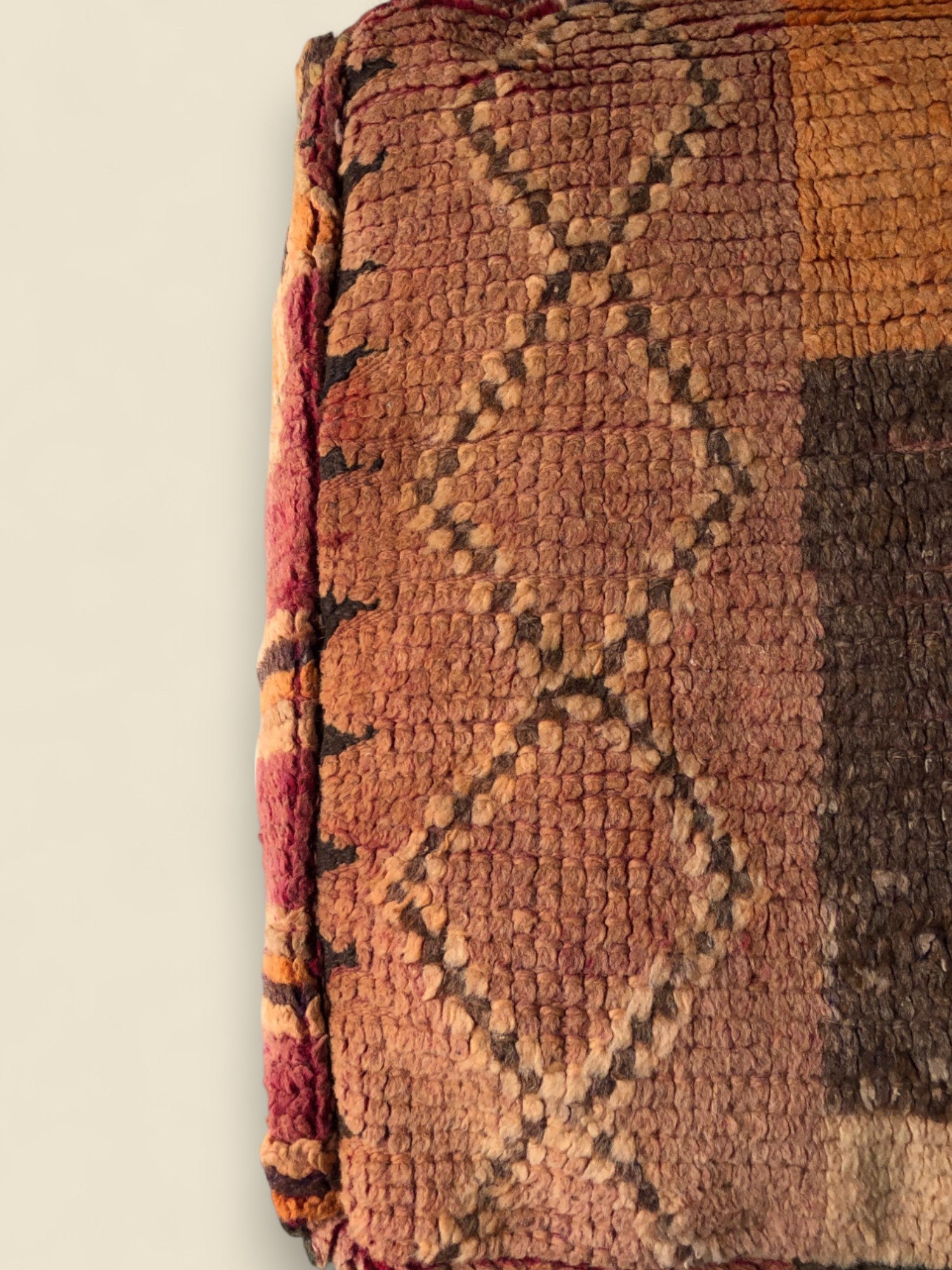Thaziza Moroccan pouffe with Berber diamond motifs in warm red and ochre tones