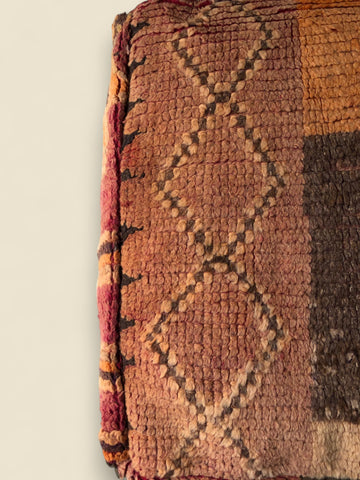 Thaziza Moroccan pouffe with Berber diamond motifs in warm red and ochre tones