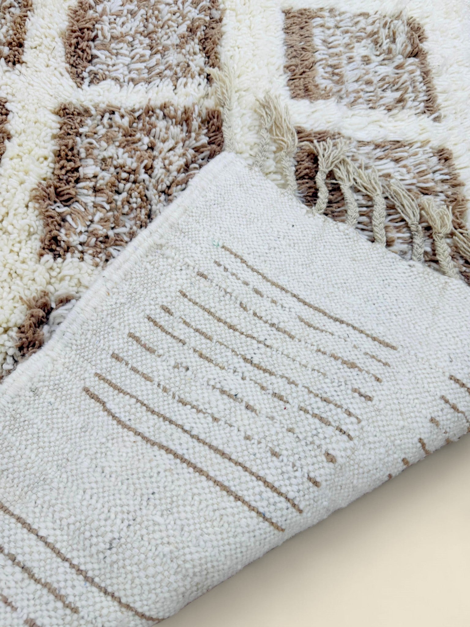 Close-up of Tilila Berber Rug with cream and brown checkered wool pattern