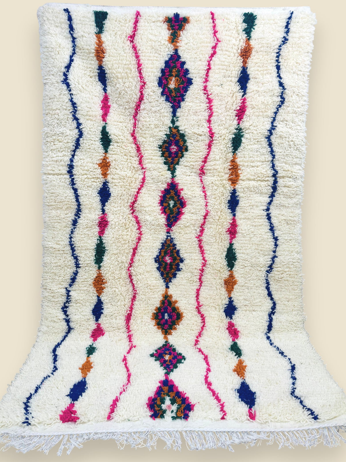 Berber wool rug with pink, blue, and orange tribal motifs