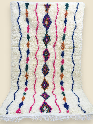 Berber wool rug with pink, blue, and orange tribal motifs
