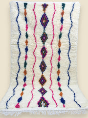 Berber wool rug with pink, blue, and orange tribal motifs