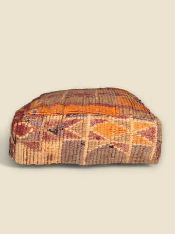 Side view of vintage Berber pouffe
