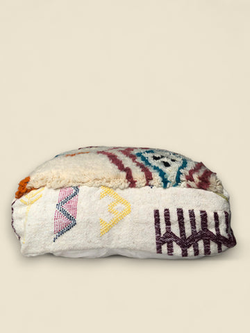 Alternate side view of the Tizerzit pouffe with hand-stitched Berber graphics in multiple colors