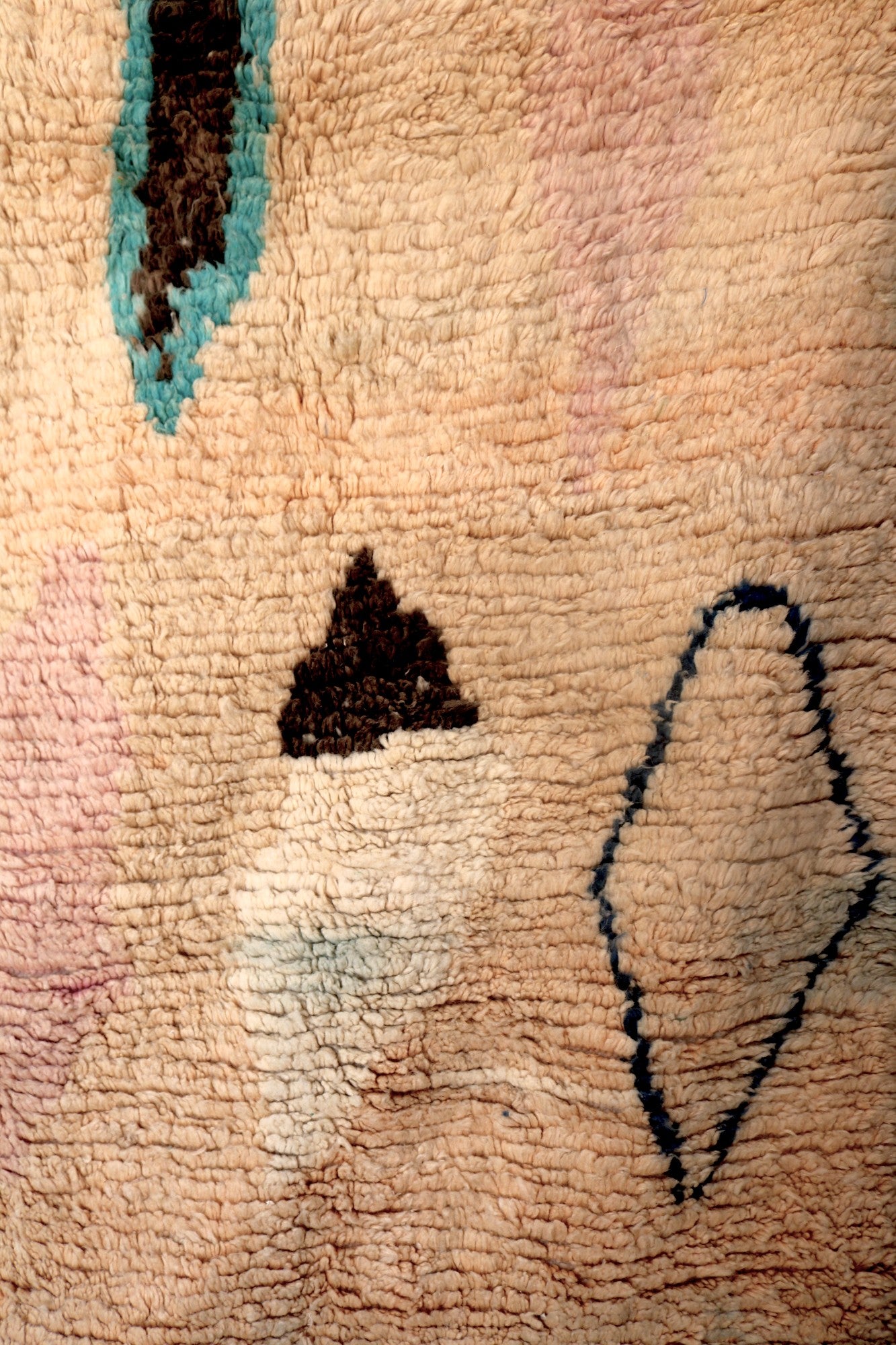 Close-up of Hafna rug motifs with triangle and diamond shapes in deep blue and brown.