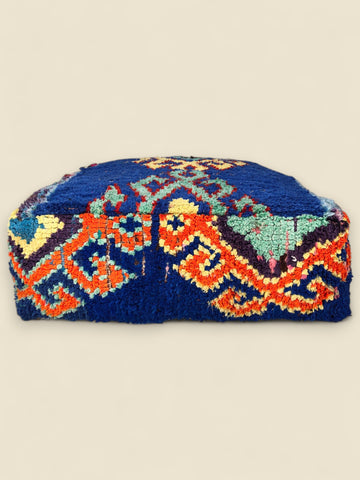 Decorative pillow with geometric pattern on a beige background