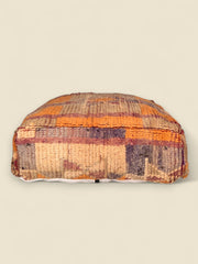 Handcrafted Moroccan pouffe with geometric Berber patterns in rustic colors