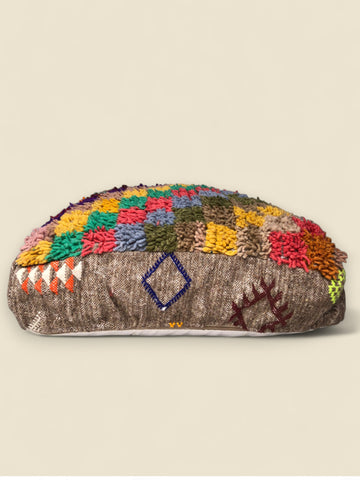 Handmade pouffe from Morocco with vibrant wool patchwork and brown base