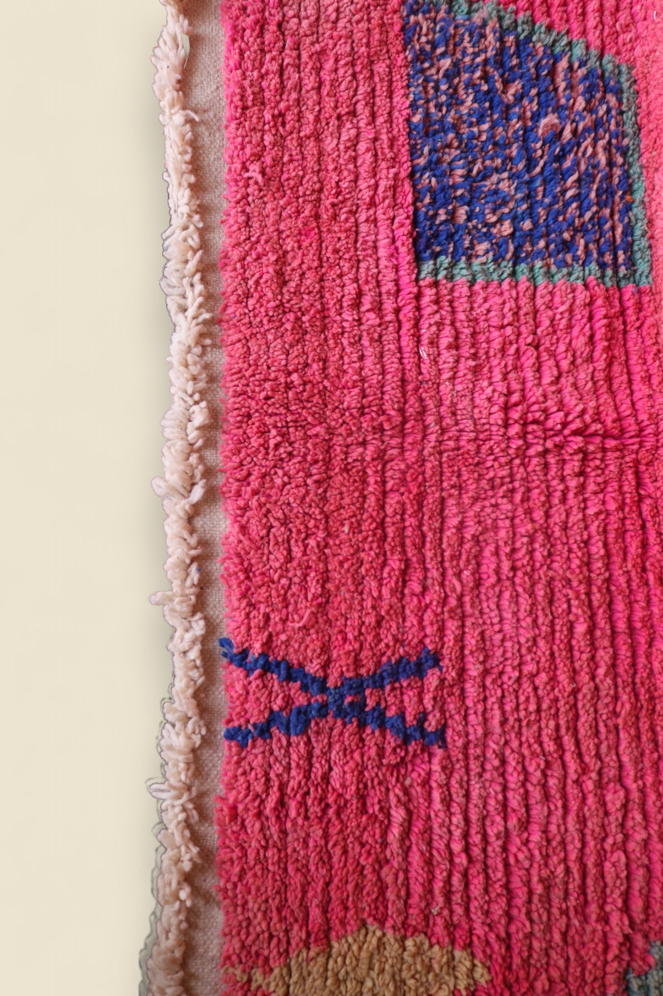 Detailed view of pink field and navy-blue woven square