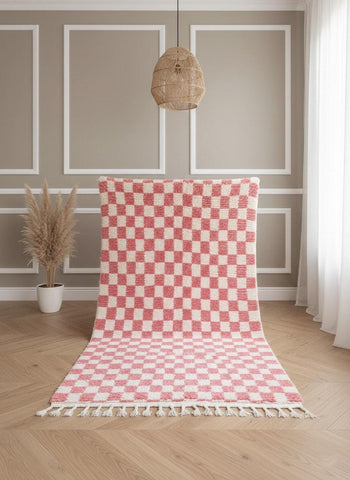 Handwoven pink checkered Berber rug displayed vertically