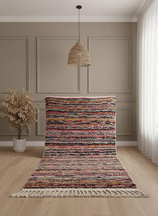 Moroccan striped wool rug with fringe laid flat indoors