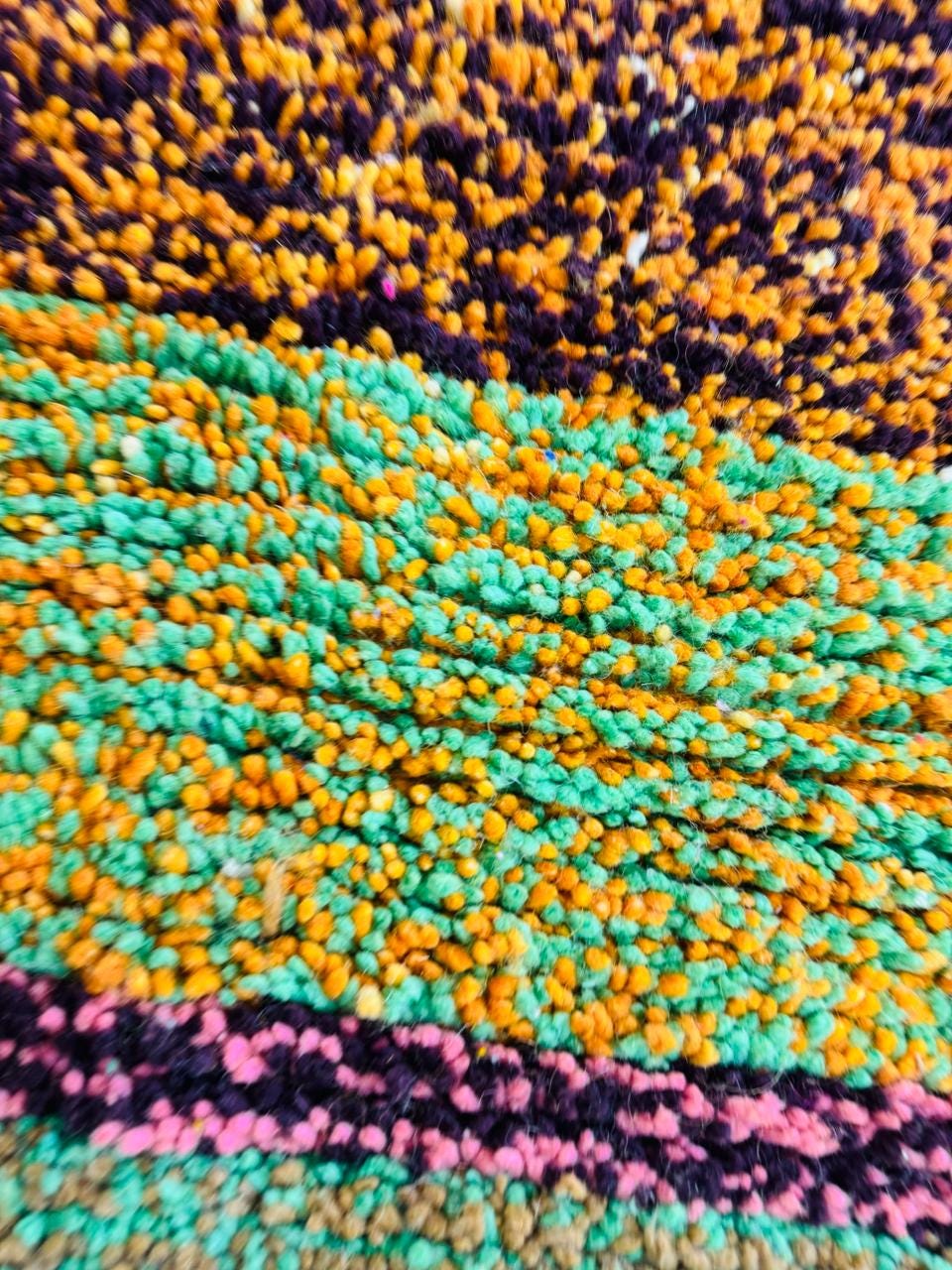 Close-up of colorful Moroccan wool rug texture.