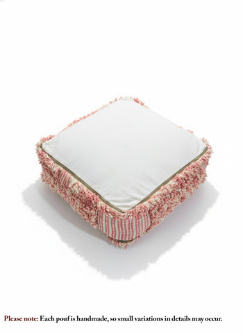 Bottom view of a Moroccan pink and white pouf showing the zippered base