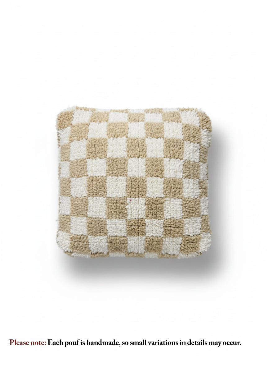 Beige and white checkered Berber pouffe on white background.