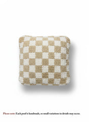Beige and white checkered Berber pouffe on white background.