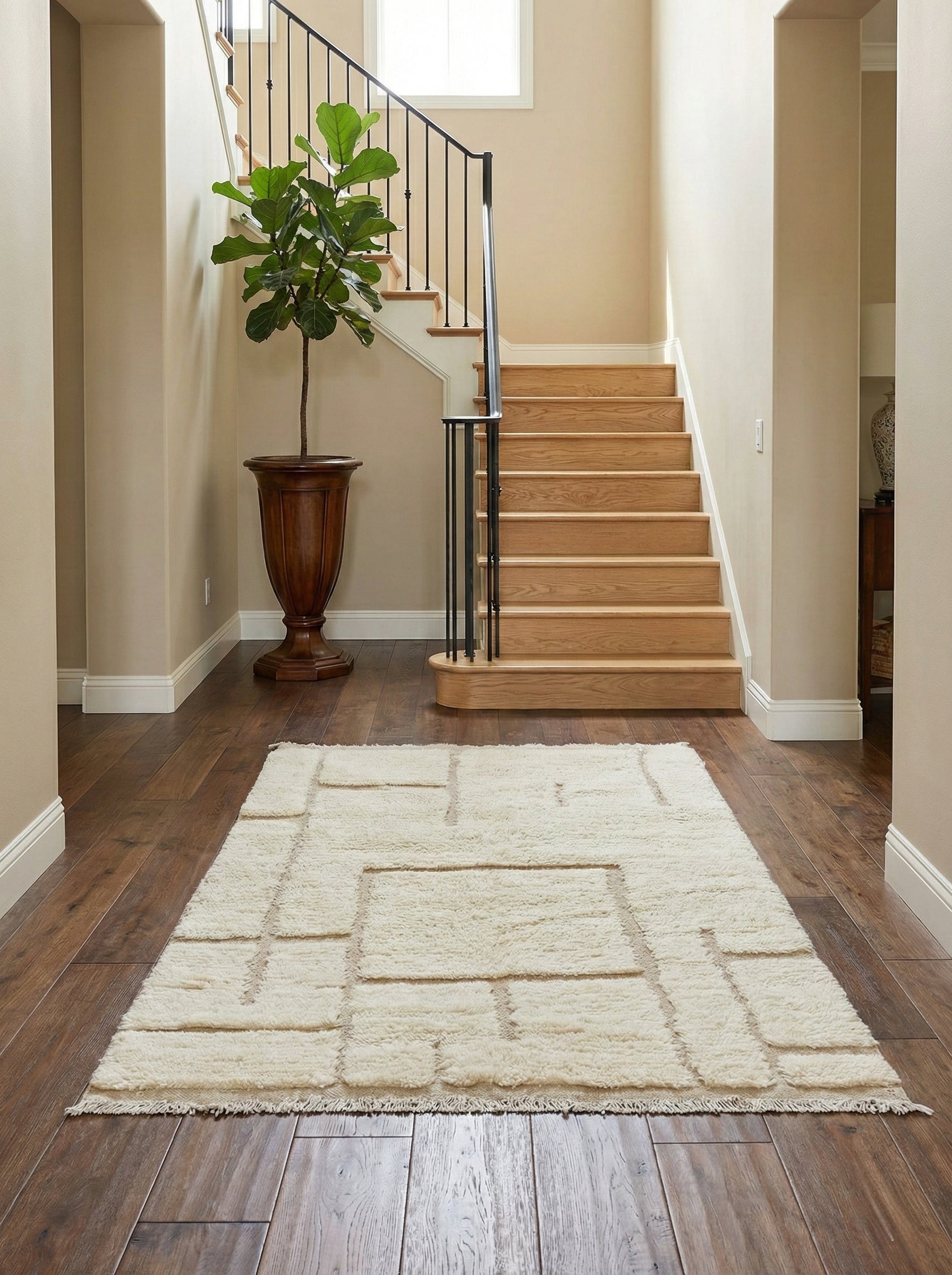 Handmade Berber Yuba wool rug placed in a modern entryway with wooden stairs.