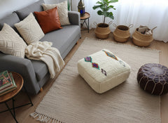 Amnay Moroccan pouf styled in a cozy living room.
