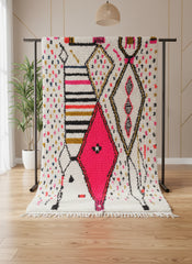 Tin Hinan colorful Berber rug displayed on stand with bold patterns