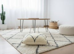 Side view of Titrit Moroccan pillow with textured wool weave and tassels