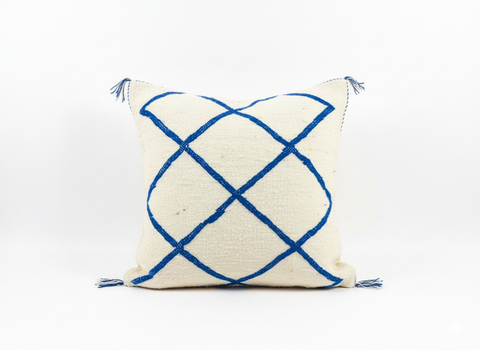 Flat Tinessa Moroccan cushion on cream rug with geometric lines