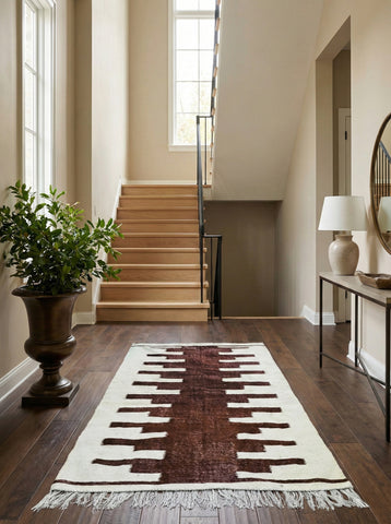Moroccan Nara rug in modern entryway near staircase

