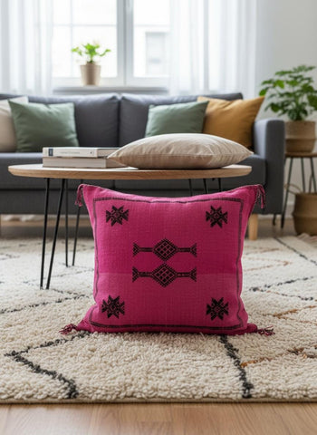 Handmade pink Sabra pillow with traditional Moroccan motifs displayed on a neutral sofa with boho decor.
