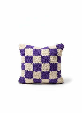 Purple and cream Moroccan checkered wool pillow on neutral background.