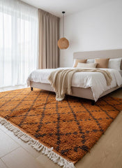 Orange Moroccan area rug in bedroom